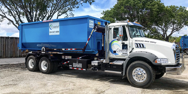 Dumpster loaded on truck in Coastal Waste's Yard in West Palm Beach, FL